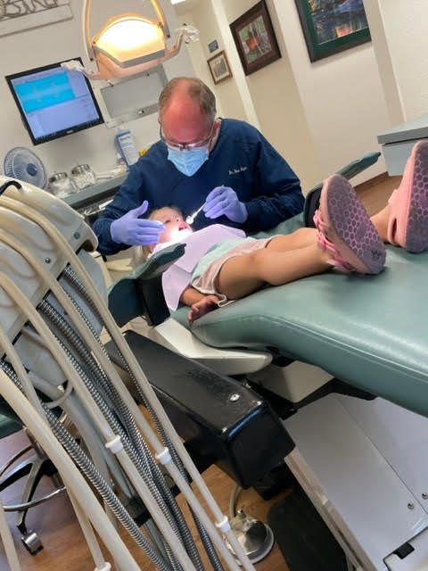 Dr. Heyn working on a little girl's teeth